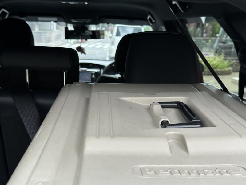 ラゲッジルーム天井のベルトで固定されたクレート