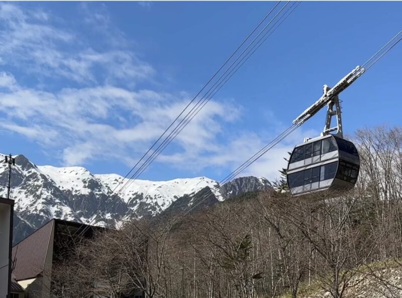 新穂高ロープウェイのゴンドラと雪をかぶった北アルプスの山々（春・2026年4月）